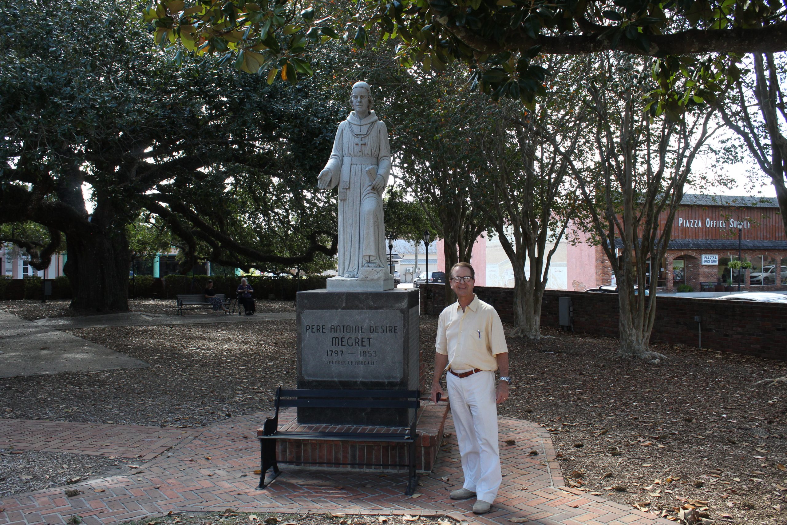 Council Member Brady Broussard, Jr Standing by Statue of Père Antoine Désiré Mégret (1797-1853)
