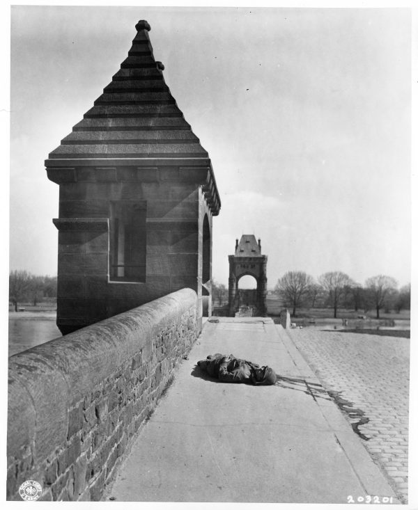 Fallen soldier on the west side of the Nibelungen Bridge, Worms, Germany, March 21, 1945.